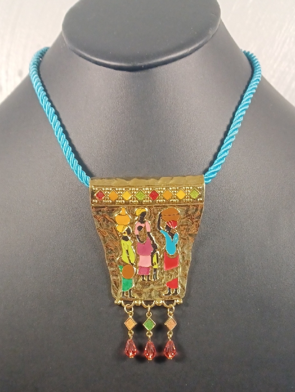"The Gathering" Goldtone Pendant On Blue Rope 18"